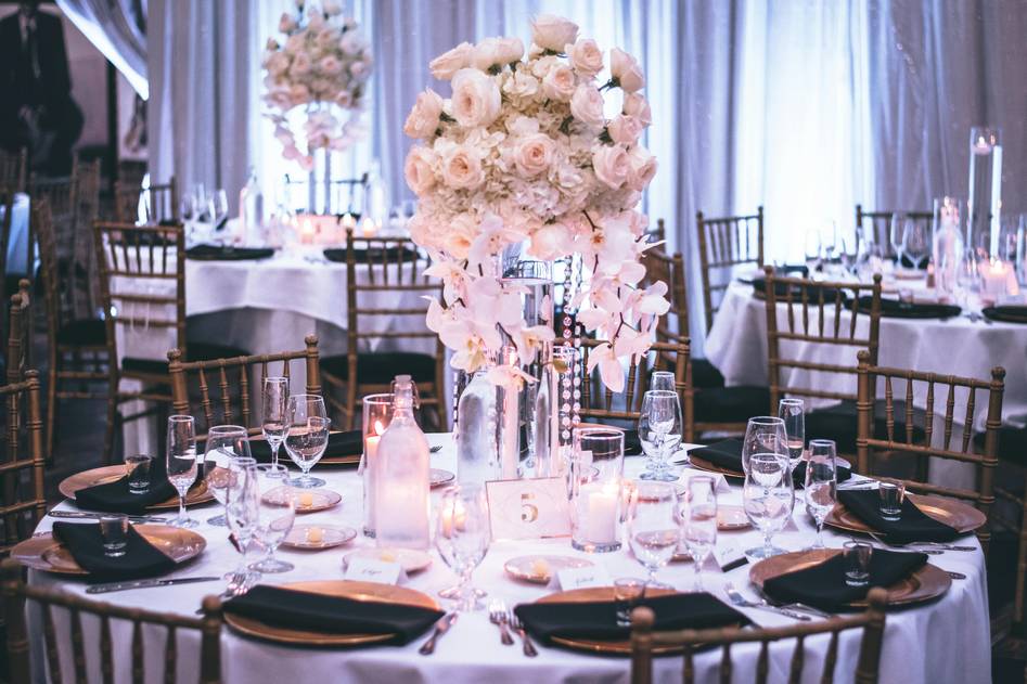 Elegant floral centerpiece with neutral vases on wooden table
